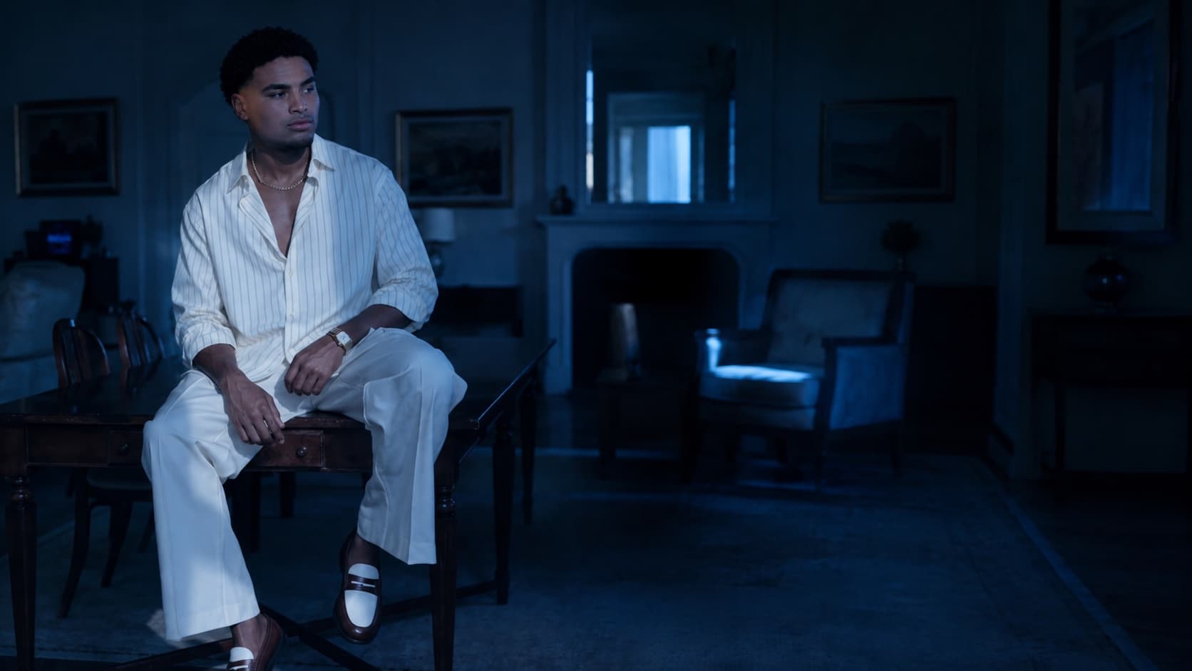 Joshua Herbert in a moody, blue-lit interior